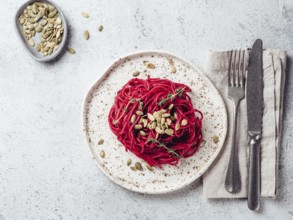 Beetroot pesto or hummus. Homemade beet pesto sauce in glass jar and fresh thyme on dark black
