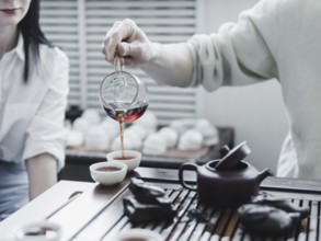 Chinese tea ceremony. Master pouring puer tea in cups. Pu erh tea ceremony