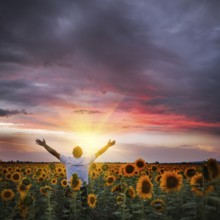 Man with raised hands enjoys with beauty world