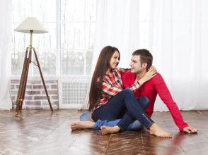 Couple in love at home relaxing on the floor