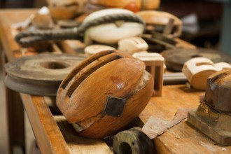 Old wooden pulleys laying at the table