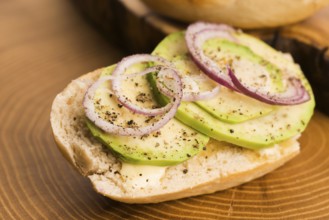 Sandwich with avocado, red onion, salt and herbs