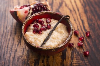 A bowl of tapioca pudding with vanilla and pomegranate