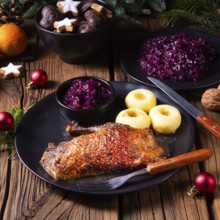 Roast goose with baked apples, red cabbage and dumplings