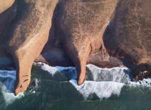 Aerial top view on Legzira beach with arched rocks on the Atlantic coast at sunset in Morocco
