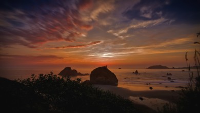 This is a color landscape photo of a vivid sunset over the Pacific Ocean
