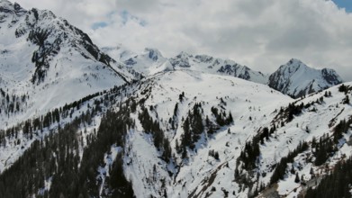 Aerial view of snow mountain range landscape with clouds. Alps mountains, Austria, Europe