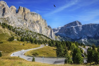 Picturesque road through the Sella Pass, Dolomites. The concept of extreme and ecological tourism.