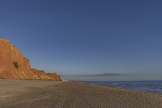 The golden sandy beach of Praia da Falésia with its characteristic orange-coloured cliffs,