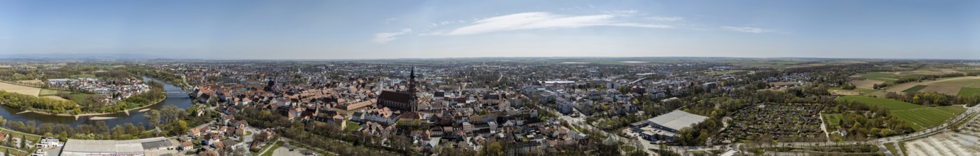 Panoramic view of a large city with river (Danube), red roofs and extensive landscape under a blue