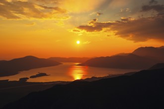 Sunset in Montenegro over the mountains and the sea. Orange sunsets