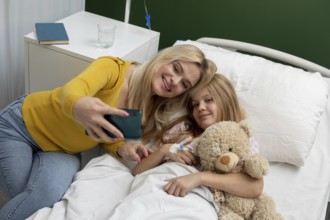 A heartwarming selfie captures a loving mother and daughter sharing a joyful moment in a hopeful