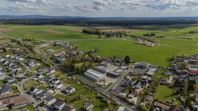 Aerial view of a village with houses, streets and fields under a slightly cloudy sky, Mitterteich,
