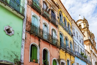 Facades of colorful houses and church in baroque and colonial style damaged by time in the