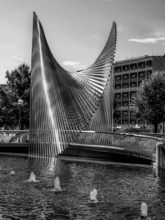 Modern steelwork in the municipal fountain, surrounded by buildings