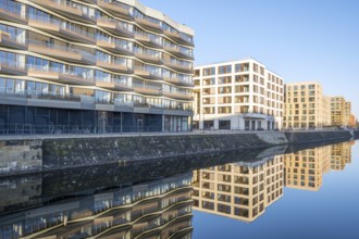 Modern apartment blocks in Berlin with a reflection in a small canal
