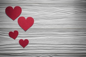 Red paper hearts on wooden board Valentine cards