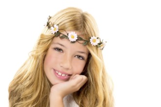 Children blond girl with spring daisy flowers crown smiling on white