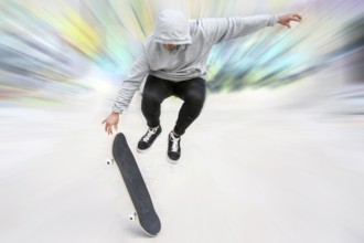 Young skater doing jump trick at skate park