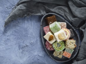 Turkish delight on blue concrete background, copy space