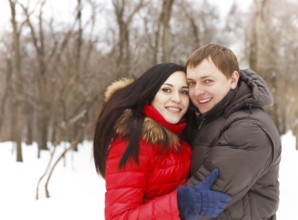 Happy young couple having fun in the winter park