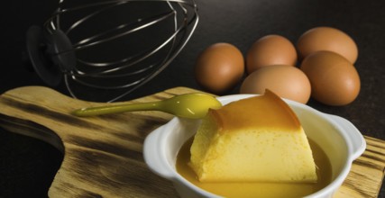 Traditional Brazilian dessert, milk pudding on dark background