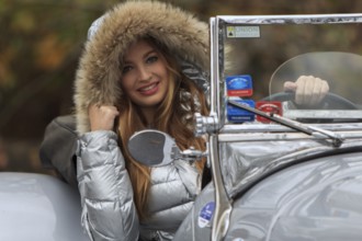 Model Isabelle poses in a 1935 Jaguar SS 100, the first car with the designation