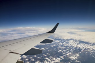 Wings of an aeroplane above the clouds