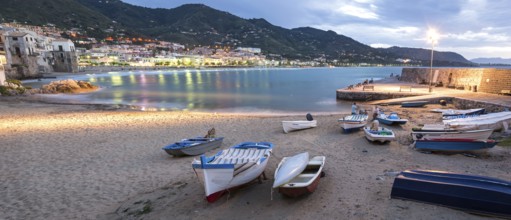 Panorama night shot of beautiful bay and fishing boats in Cefalu, Sicily, Italy, Europe