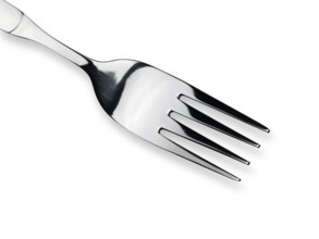 Single fork over the white background