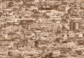 A sepia duotone crowded urban cityscape background with hundreds of densely packed buildings