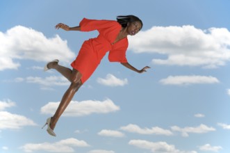 Beautiful young woman falling through the sky
