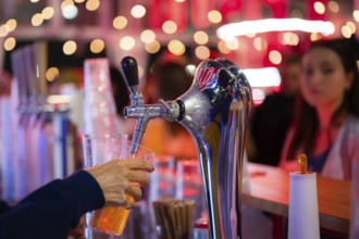 Pouring draft beer into a mug in a pub