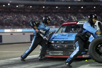 The crew of Niece Motorsports work on the car prior to performs a pit stop on pit road during the