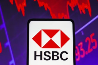 In this photo illustration the HSBC logo seen displayed on a smartphone screen, with graphic
