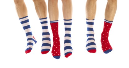 Feet in striped and dotted socks isolated over white background