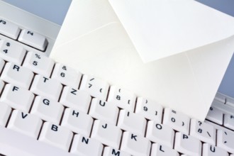 The keyboard of a computer and an envelope. Communication via e-mail, The keyboard of a computer