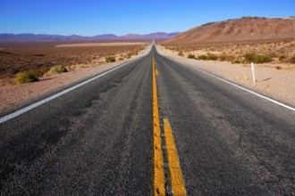 Never ending road to Death Valley California sunny desert