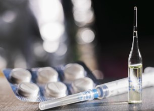 Pills, Syringe And Ampoule With Vaccination On Dark Table