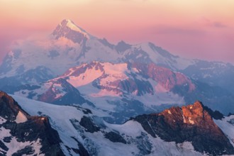 Colorful pink sunrise in mountains. Caucasus, Russia, Europe
