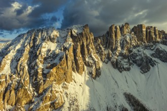 Aerial view of amazing rocky mountains in snow at sunset, Dolomites, Italy, Europe