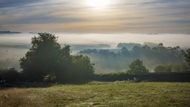 Early morning sunrise landscape with fog and mist in the rural part of Galicia, Spain, Europe