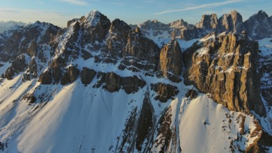 Aerial view of amazing rocky mountains in snow at sunrise, Dolomites, Italy, Europe