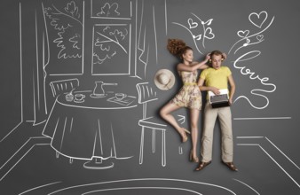 Love story concept of a romantic couple against chalk drawings background. Male listening to music