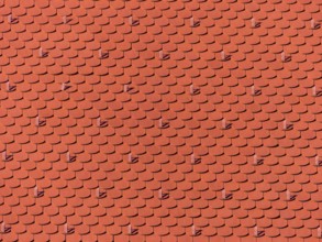 The roof of an old building (church) has been freshly renovated. New roof tiles on Haus Austria