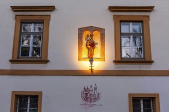 Sculptural group in a niche, saint holding the infant Jesus, depiction of the dissolution decree of