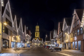 Night photo of historic buildings around the market square with Christmas tree and Christmas lights