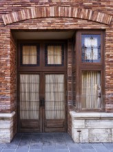 Vintage wooden door of old brick Venetian house