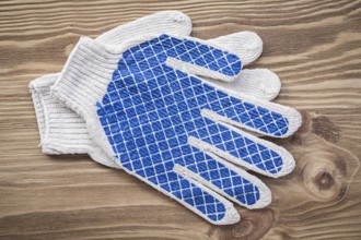 Protective gloves on wooden board construction concept