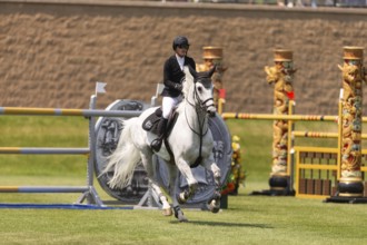 Carly Campbell-Cooper of Canada and riding Baretino, compete in the 1.60m Grand Prix during The